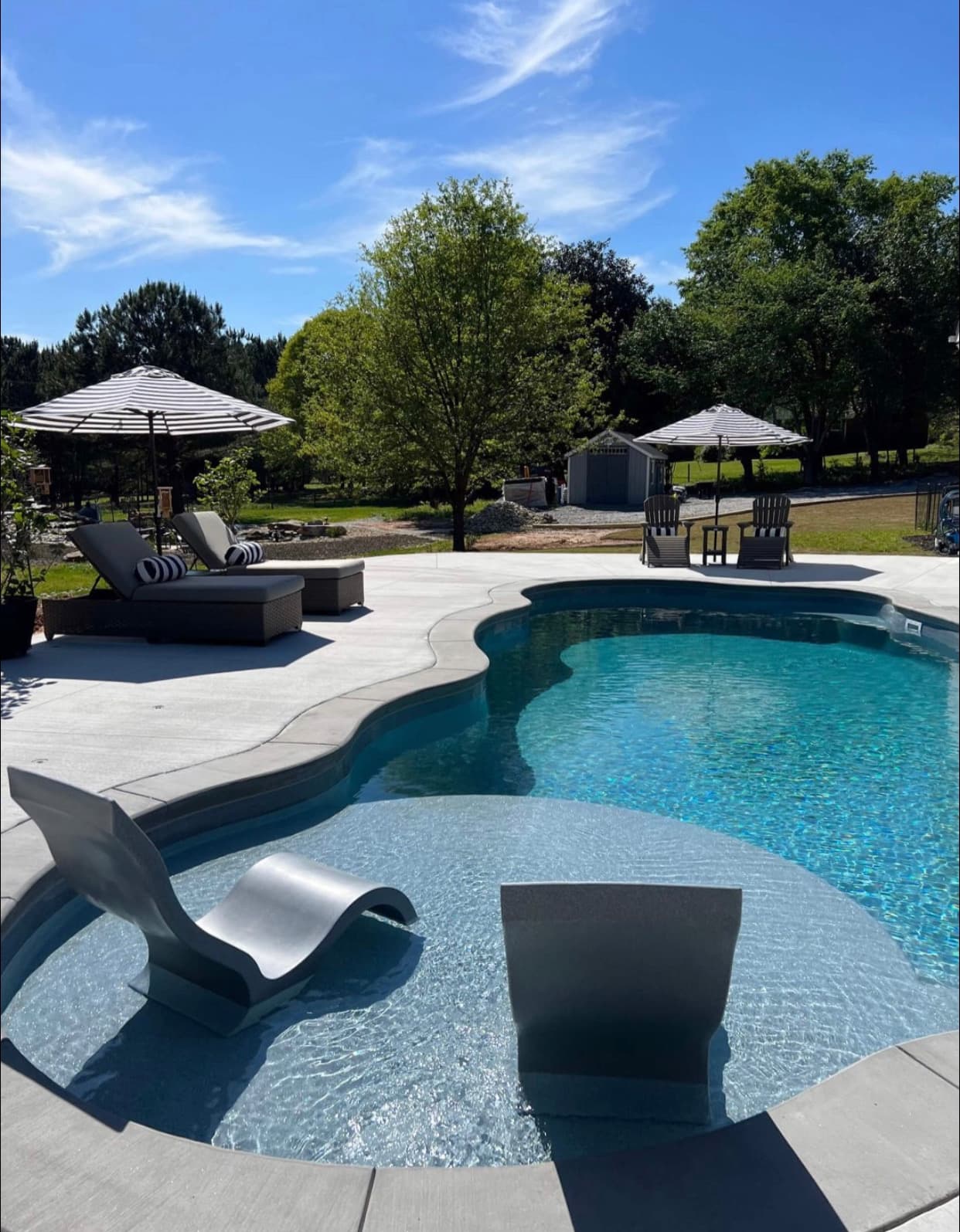 Finished pool and patio with pergola and outdoor living area.