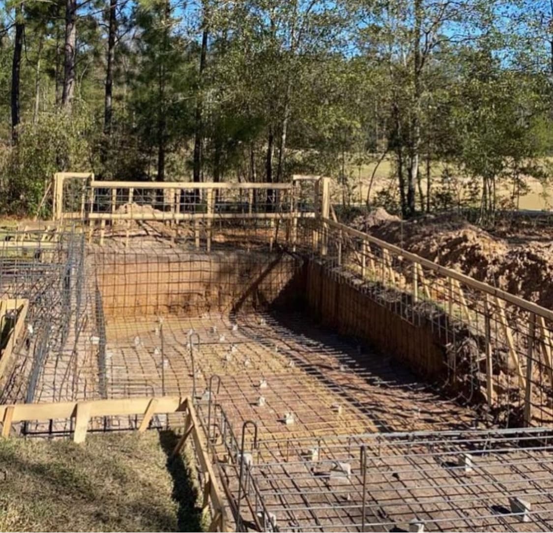 Backyard poolscape with broad hardscape zone.