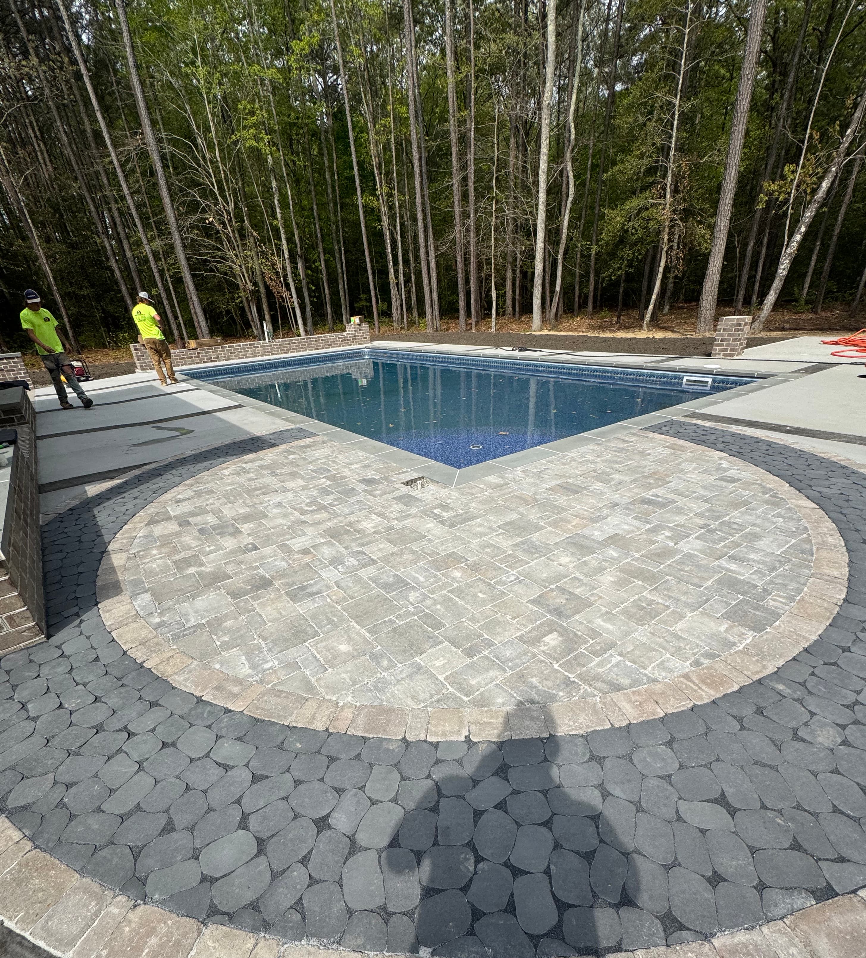Geometric pool with premium bluestone deck surround.