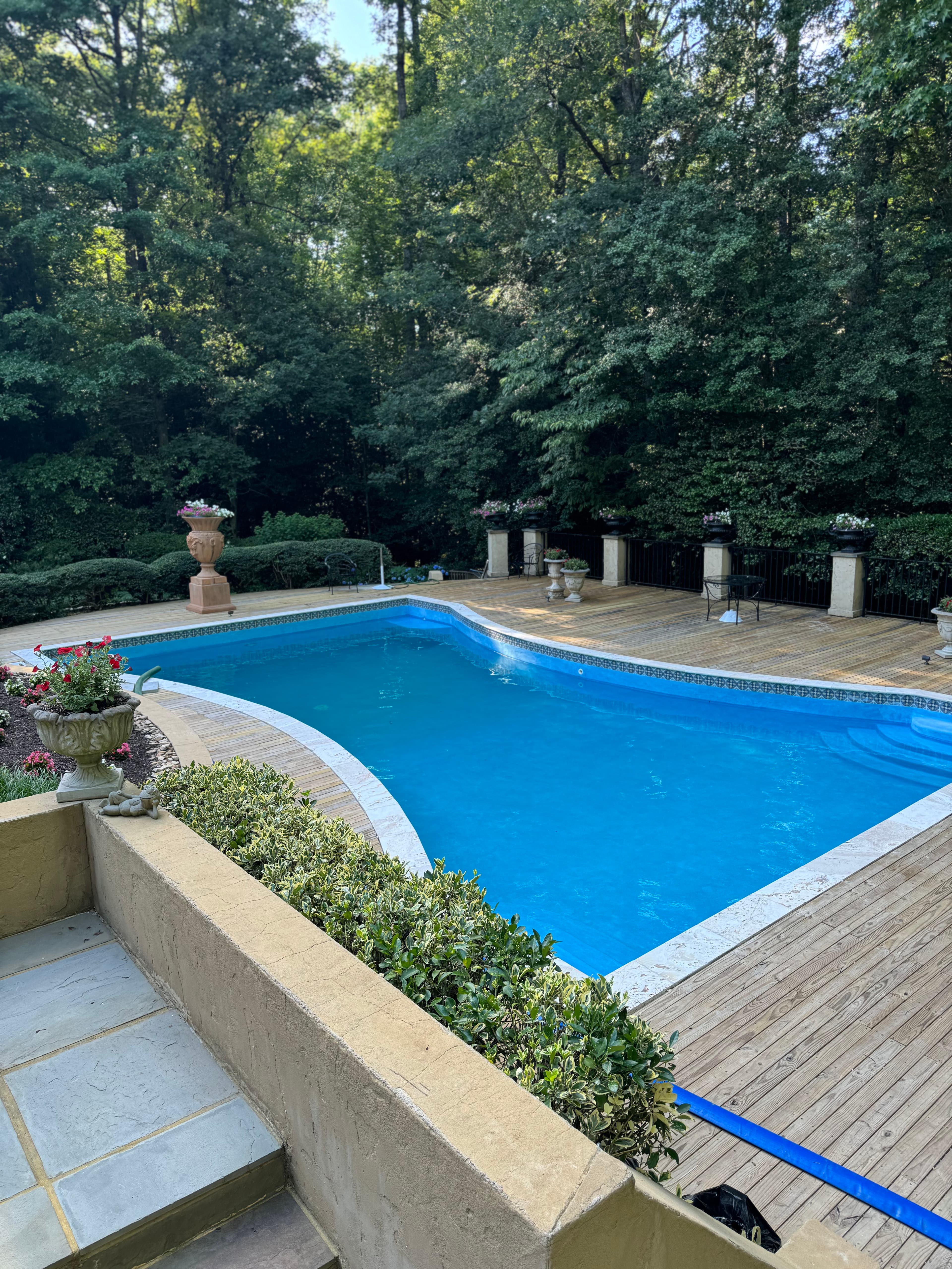 Luxury pool renovation with integrated spa and stonework.
